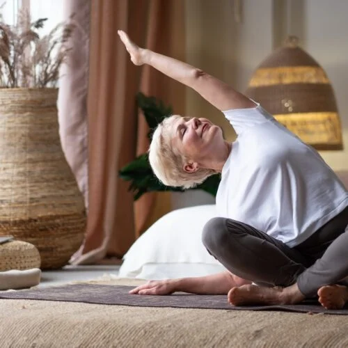 Mature,Woman,Doing,Stretching,Yoga,Side,Bend,At,Home.